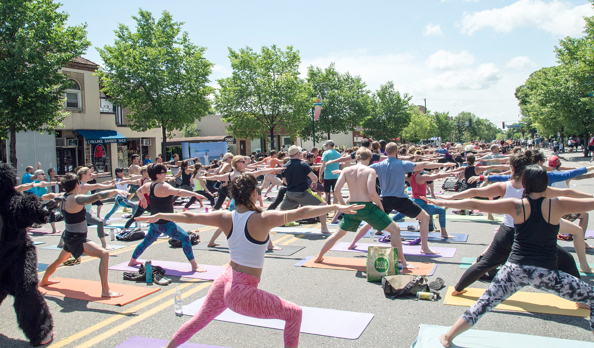 People perform yoga in the middle of Lyndale Avenue during an Open Streets event. 
